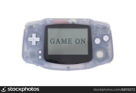 Old dirty portable game console with a small screen - game on