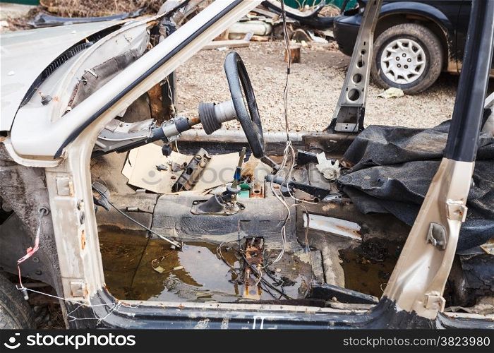 old disassembled car at an automobile dump