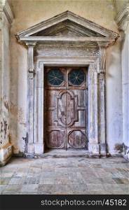 Old door in monastery. Pazaislis monastery and church is a large monastery complex in Kaunas, Lithuania, and the example of Italian Baroque architecture&#xD;