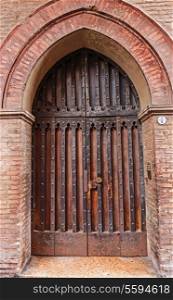 Old door in the medieval Italian house in Bologna