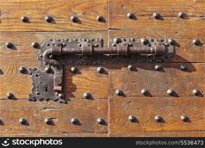 Old door lock on a wooden door