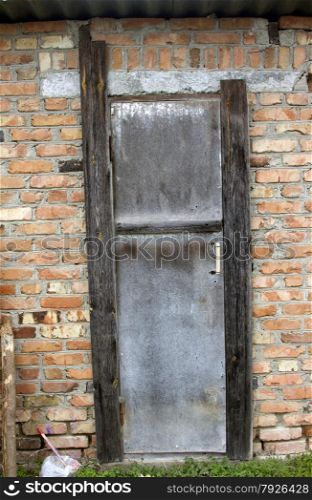 Old door on a brown brick wall great background.. Single Wooden Door in Old City Wall