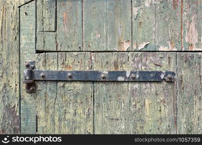 Old door rusty hinge in close-up.