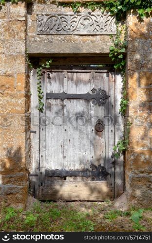 Old doorway to Cotswold manor house garden, Warwickshire, England.