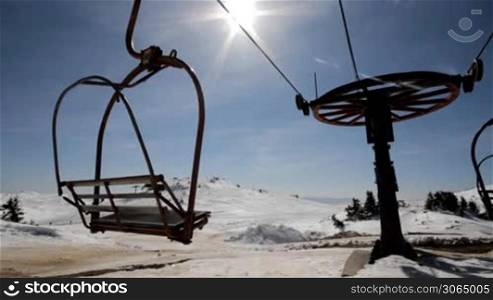 Old double seat ski lift out of work on beautiful sunny day on mountain