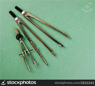 Old drawing tools on a green background