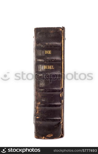 "Old Dutch Bible standing upright on an isolated white background with the back of the book and the words "Die Bibel" clearly visible."