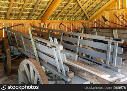 Old Dutch farmhouse with shed and wooden carriages. Dutch farmhouse with old shed and wooden carriages