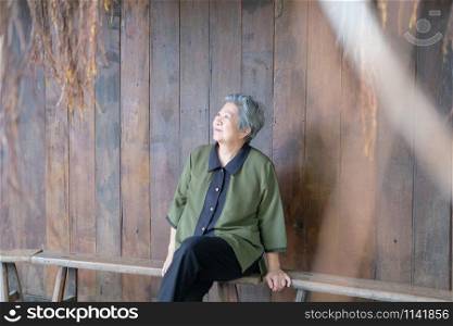 old elder woman sitting at home. elderly female relaxing outdoors. senior leisure lifestyle