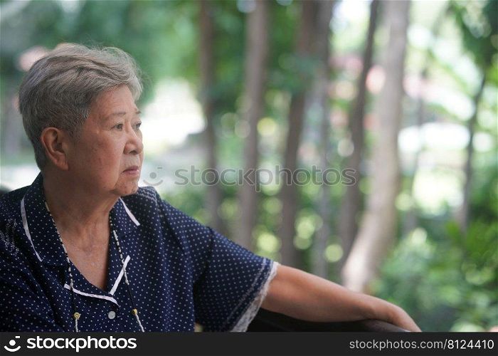 old elderly elder senior woman resting relaxing on balcony near garden