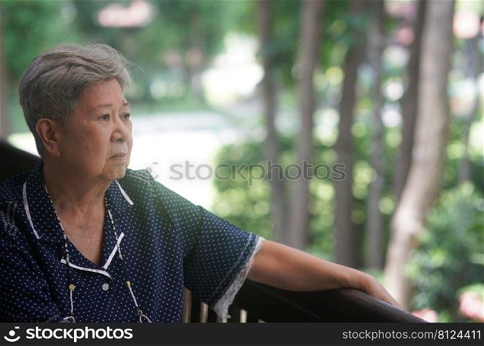 old elderly elder senior woman resting relaxing on balcony near garden