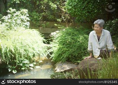 old elderly elder senior woman resting relaxing walking in garden
