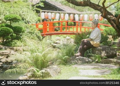 old elderly elder senior woman resting relaxing walking in garden