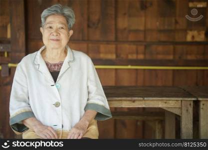 old elderly senior elder woman relaxing on terrace patio. mature retirement lifestyle