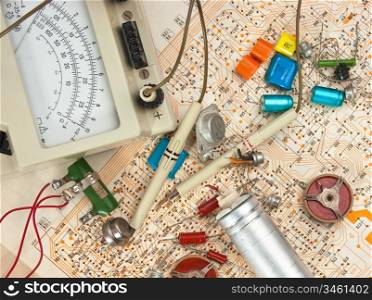 Old electronic components lie on the wiring diagram