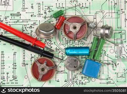 Old electronic components lie on the wiring diagram