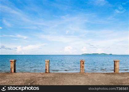 Old empty concrete ship port pier deck tropicl blue summer sky bright sunlight with island view