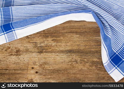 old empty wooden table and cloth blue napkin. frame of blue napkin