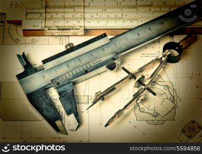 Old engineering tools on a technical drawing
