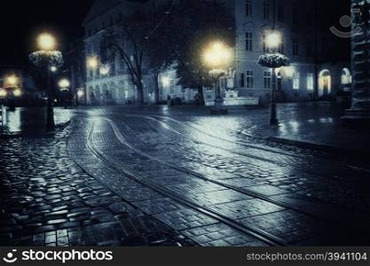 Old European city at rainy night