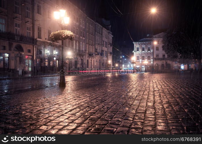 Old European city at rainy night