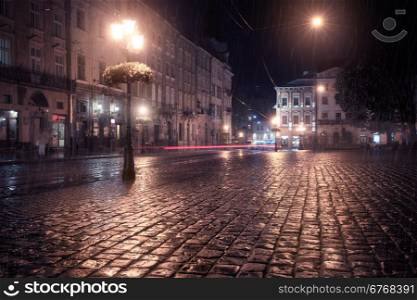 Old European city at rainy night