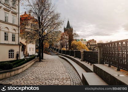 Old european cobblestone embankment over Vltava river. Cozy empty cityscape. . High quality photo. Old european cobblestone embankment over Vltava river. Cozy empty cityscape. 