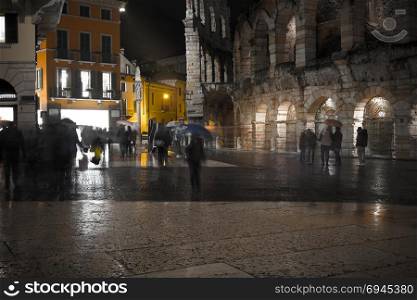 Old European illuminated city at rainy night