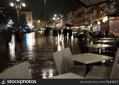 Old European rainy night city out of focus background