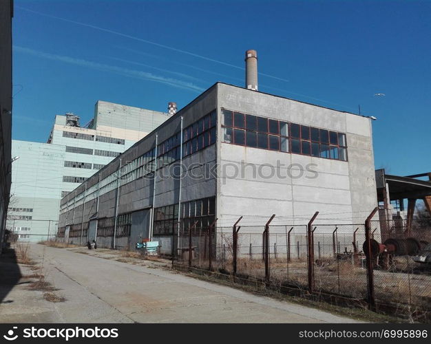 Old factory construction on the background of sky.