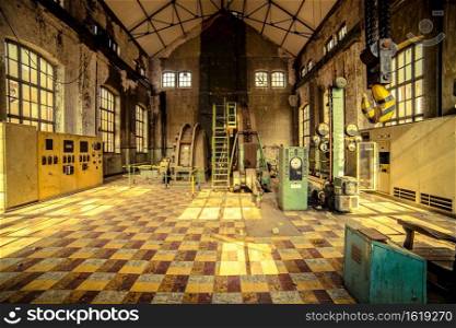 Old factory hall with tiles on the floor
