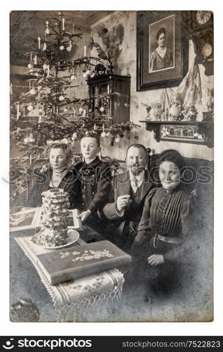 Old family photo parents andchildren. Vintage home interior with Christmas tree