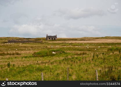 Old farm cottage and field on Islay