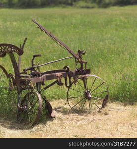 Old farm equipment in grass