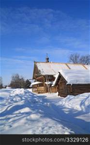 old farmhouse amongst white snow