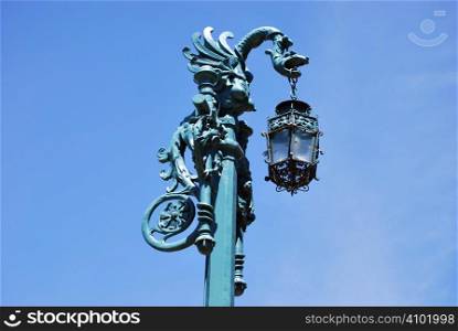 Old fashined lamp with a dragon over the sky