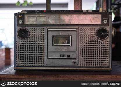 Old fashioned audio tape player on top desk wood background