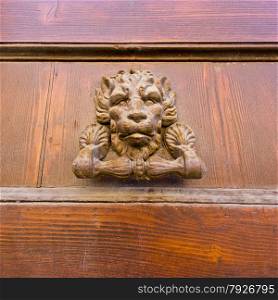 Old fashioned bronze door handle in Ravenna, Italy