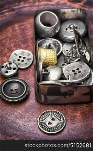 Old-fashioned button vintage. Stylish metal buttons for clothes in retro box