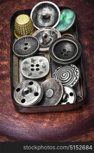 Old-fashioned button vintage. Stylish metal buttons for clothes in retro box