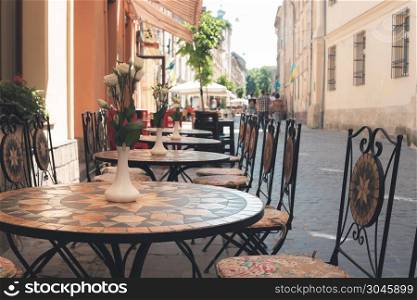 Old fashioned cafe terrace in small European street. Old fashioned cafe terrace