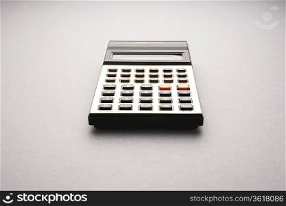 Old fashioned calculator on white background, studio shot