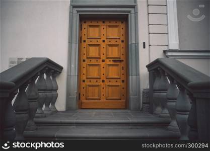 Old fashioned doors in classic style on old building facade background. European designed