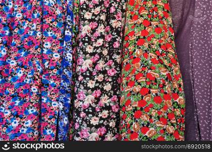 Old fashioned garments with floral pattern abstract textile colorful fabric background texture.