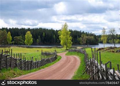 Old fashioned gravel road to the village Stensjo in the swedish province Smaland.