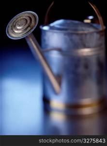 old fashioned metal watering can photographed with a shallow depth of field