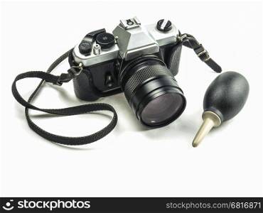 Old fashioned single lens reflex camera with rubber blower pump cleaner isolated over white background