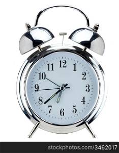 Old-fashioned style silver alarm clock, isolated against a white background