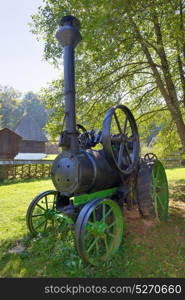 Old fashionned thresher in small village