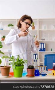 Old female biotechnology chemist working in the lab 